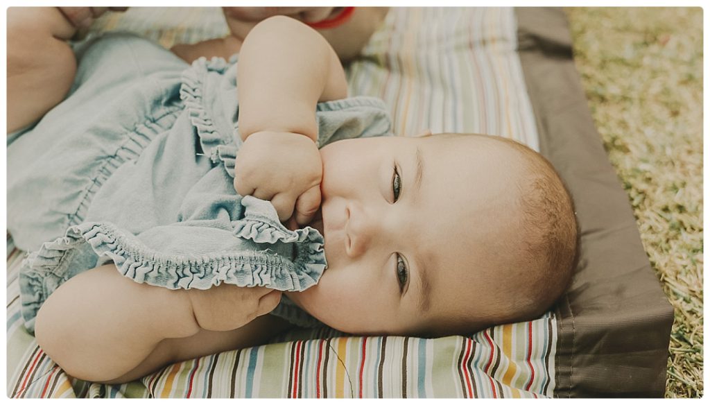 baby-looks-to-the-camera-with-a-smile-photo