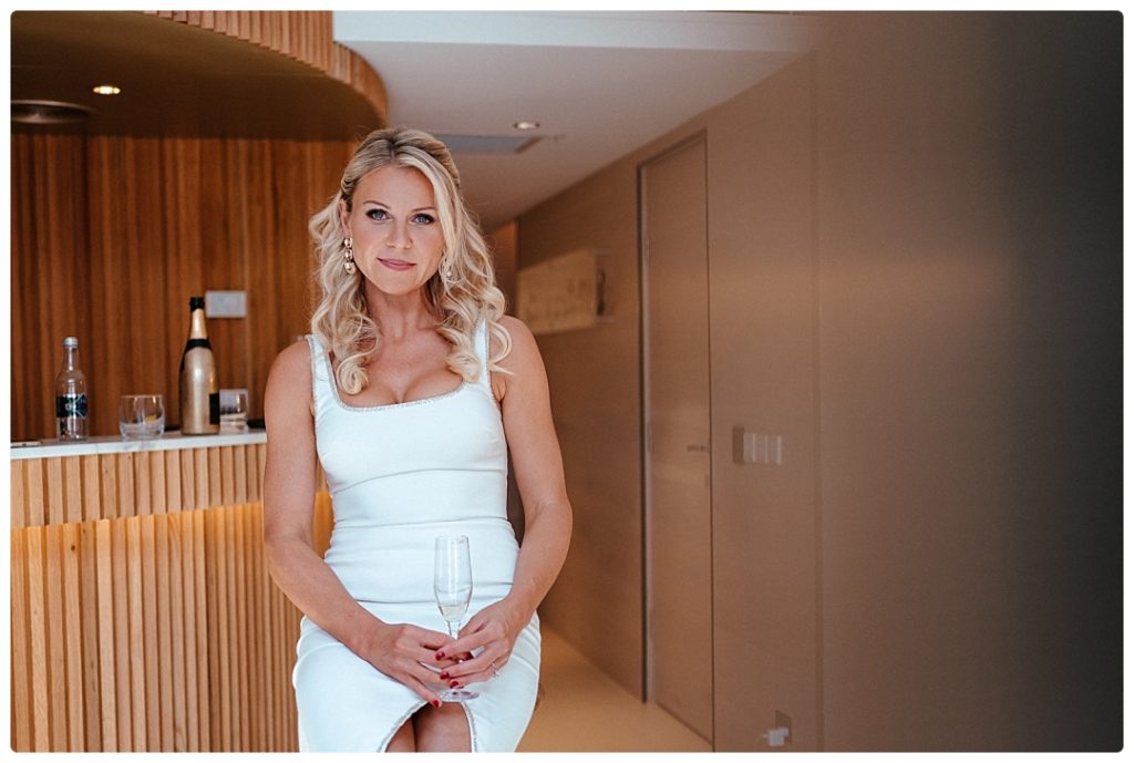 bride drinks shampagne in olovo hotel room in sydney